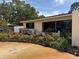 Home's well-manicured front yard displaying colorful flowers and greenery, complementing the exterior's design and appeal at 6226 Hampton N Ct, St Petersburg, FL 33710