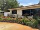 View of home showcasing a well-manicured garden with vibrant flowers and a lush green lawn at 6226 Hampton N Ct, St Petersburg, FL 33710