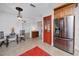 Kitchen area with stainless appliances, wooden cabinetry and red accent doors adjacent to the dining area at 6226 Hampton N Ct, St Petersburg, FL 33710