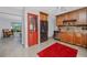 Kitchen area with stainless appliances, granite countertops, wooden cabinetry and a red accent rug at 6226 Hampton N Ct, St Petersburg, FL 33710