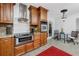Kitchen area with stainless steel appliances, granite countertops, tile backsplash and access to the dining area at 6226 Hampton N Ct, St Petersburg, FL 33710