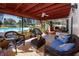 Relaxing screened patio area with wicker furniture, view of the refreshing pool and lush backyard at 6226 Hampton N Ct, St Petersburg, FL 33710