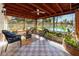 Enclosed patio with tile floors, wicker furniture, and a view of the pool at 6226 Hampton N Ct, St Petersburg, FL 33710