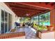 Screened patio with checkered floors, patio furniture, and access to the pool area at 6226 Hampton N Ct, St Petersburg, FL 33710