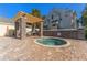 Community hot tub with pergola and brick surround, set in a landscaped area, perfect for relaxation and socializing at 3300 Haviland Ct # 303, Palm Harbor, FL 34684