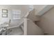 Well-lit staircase with carpeted steps and a window on the landing, leading to the upper level of the home at 3300 Haviland Ct # 303, Palm Harbor, FL 34684