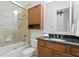 Bathroom with tub and shower combination with wood cabinets at 4023 W Horatio St, Tampa, FL 33609