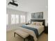 Bright bedroom features shuttered windows, a projector, and a king-sized bed with a stylish blue throw at 4023 W Horatio St, Tampa, FL 33609