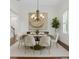 Formal dining room with chandelier, designer rug, and staircase access at 4023 W Horatio St, Tampa, FL 33609