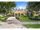 Charming home featuring manicured landscaping, stone accents, and a welcoming front porch at 4023 W Horatio St, Tampa, FL 33609