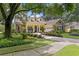 A well-maintained front yard leading up to a yellow two-story home at 4023 W Horatio St, Tampa, FL 33609