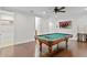 Spacious game room with wood floors, pool table, and TV at 4023 W Horatio St, Tampa, FL 33609