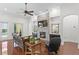 Cozy living room features stone fireplace, ceiling fan, and access to outdoor area at 4023 W Horatio St, Tampa, FL 33609