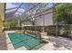 A stunning view of the screened-in pool area with beautiful water features at 4023 W Horatio St, Tampa, FL 33609