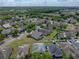Aerial view of a home boasting a lush green yard, white fence, and neighborhood views at 4351 Highcroft Dr, Wesley Chapel, FL 33545