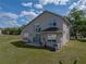 Back exterior of home with expansive yard, large windows and patio area at 4351 Highcroft Dr, Wesley Chapel, FL 33545