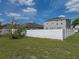 Expansive backyard featuring lush green grass, a white fence, and a view of the home at 4351 Highcroft Dr, Wesley Chapel, FL 33545