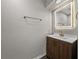 Modern bathroom with a wood vanity, an illuminated mirror, and sleek fixtures at 4351 Highcroft Dr, Wesley Chapel, FL 33545