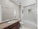 Bright bathroom featuring tub/shower combo, large mirror, and modern fixtures at 4351 Highcroft Dr, Wesley Chapel, FL 33545