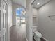 Compact bathroom features a toilet with a view of the living area at 4351 Highcroft Dr, Wesley Chapel, FL 33545