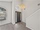Spacious entryway featuring high ceilings, modern chandelier, and a statement front door with side windows at 4351 Highcroft Dr, Wesley Chapel, FL 33545