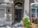Close-up of the home's front entryway, showcasing an elegant door and well-kept landscaping at 4351 Highcroft Dr, Wesley Chapel, FL 33545