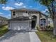 Beautiful exterior showcasing a two-story home with an attached two-car garage and landscaped front yard at 4351 Highcroft Dr, Wesley Chapel, FL 33545