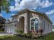 Close up of house exterior featuring a well-maintained lawn and attractive landscaping at 4351 Highcroft Dr, Wesley Chapel, FL 33545