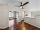 Wood-floored hallway with ceiling fan providing access to rooms and views of the neighborhood at 4351 Highcroft Dr, Wesley Chapel, FL 33545