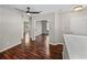 Hallway with wood floors leading to various rooms, illuminated by a ceiling fan and lights at 4351 Highcroft Dr, Wesley Chapel, FL 33545