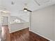 Hallway with wood floors featuring a ceiling fan and views of neighboring buildings outside windows at 4351 Highcroft Dr, Wesley Chapel, FL 33545