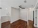 Well-lit hallway features wood floors and provides access to multiple rooms in the home at 4351 Highcroft Dr, Wesley Chapel, FL 33545