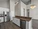 Kitchen island featuring modern appliances, bar seating, and stainless steel dishwasher at 4351 Highcroft Dr, Wesley Chapel, FL 33545