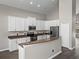 Well-equipped kitchen featuring an island with bar seating and stainless steel appliances at 4351 Highcroft Dr, Wesley Chapel, FL 33545