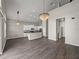 Open-concept living space with a kitchen, modern lighting, and high ceilings at 4351 Highcroft Dr, Wesley Chapel, FL 33545