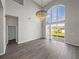 Spacious living room boasts soaring ceilings, a grand chandelier, and access to the backyard at 4351 Highcroft Dr, Wesley Chapel, FL 33545