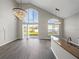 Open living space with a view to the backyard, vaulted ceiling, and elegant chandeliers at 4351 Highcroft Dr, Wesley Chapel, FL 33545