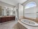 Large main bathroom features a soaking tub and double vanity at 4351 Highcroft Dr, Wesley Chapel, FL 33545