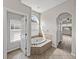 Bright main bathroom with a soaking tub and tile floors at 4351 Highcroft Dr, Wesley Chapel, FL 33545