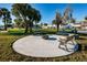 Charming outdoor firepit with surrounding benches creating a relaxing social space amidst lush greenery at 5257 81St N Ln # 16, St Petersburg, FL 33709