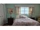 Comfortable bedroom with nautical bedding, bedside lamps, and ample closet space at 5975 Terrace Park N Dr # 102, St Petersburg, FL 33709