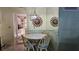 Cozy dining area featuring a round table with wicker chairs and unique decorative wall hangings at 5975 Terrace Park N Dr # 102, St Petersburg, FL 33709