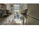 Galley kitchen leading to an outdoor patio with modern appliances and neutral decor at 5975 Terrace Park N Dr # 102, St Petersburg, FL 33709