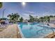 Large community pool with lounge chairs and accessible access at 5975 Terrace Park N Dr # 102, St Petersburg, FL 33709
