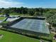 Aerial view of tennis courts, surrounded by trees, offering recreational opportunities at 5975 Terrace Park N Dr # 102, St Petersburg, FL 33709