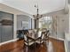 Elegant dining room featuring dark wood floors, a chandelier, and a large window with natural light at 6307 Bridgevista Dr, Lithia, FL 33547