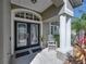 Close up of the front entrance with decorative glass door and manicured landscaping at 6307 Bridgevista Dr, Lithia, FL 33547