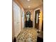 The foyer features decorative mirror, lighting and tile flooring at 7711 Innis Ct, St Petersburg, FL 33709