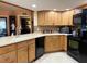 Bright kitchen with light colored counter tops, oak cabinets, backsplash and updated appliances at 7711 Innis Ct, St Petersburg, FL 33709
