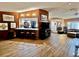 Open-concept living area featuring wood paneling and a view into kitchen with breakfast bar at 7711 Innis Ct, St Petersburg, FL 33709